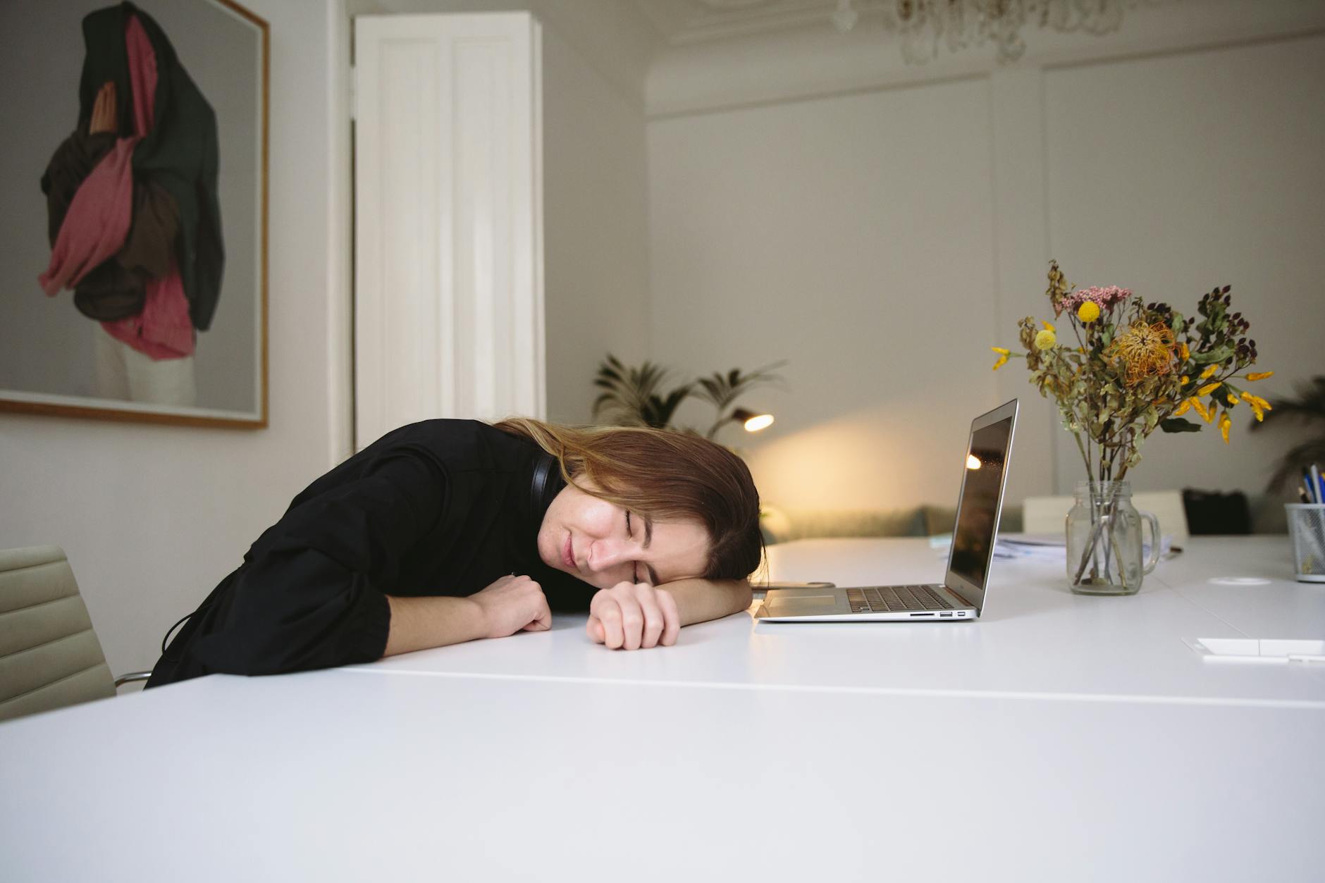 photo of woman sleeping on table